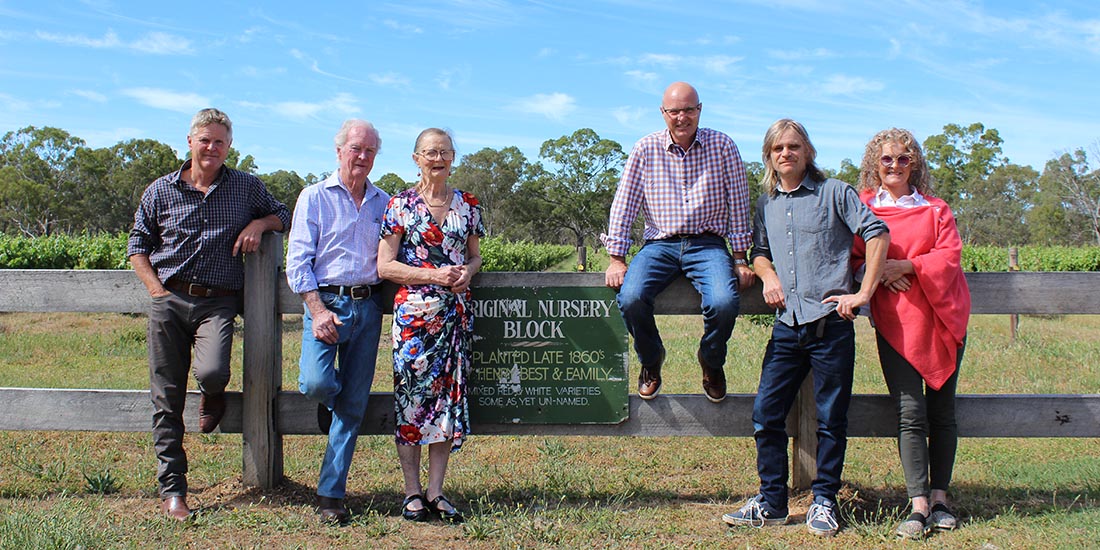 Thompsom family posing in front of nursery block in vineyard. 